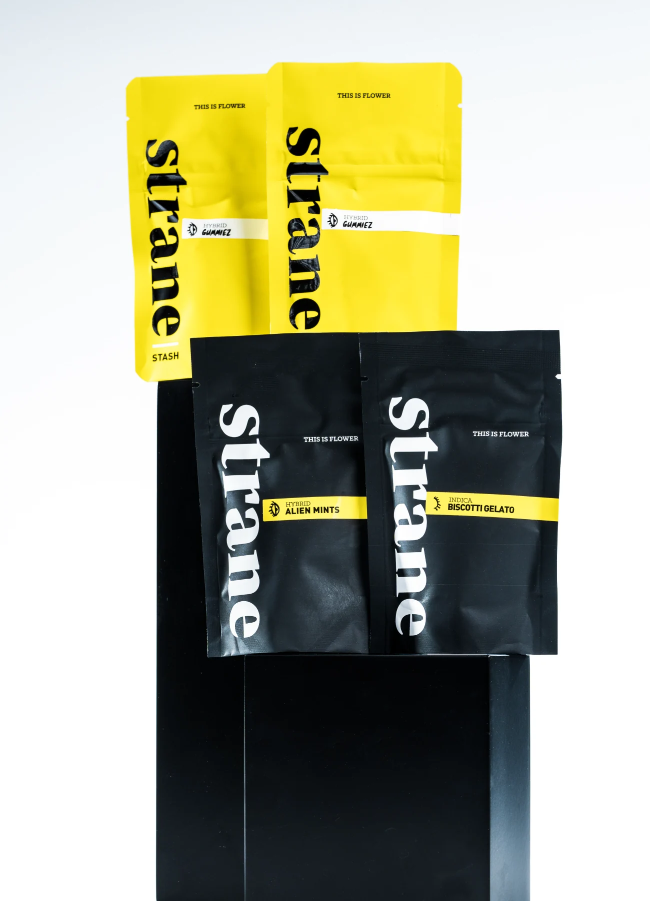 Legacy Strane packaging with simple vertical wordmarks and strain labels